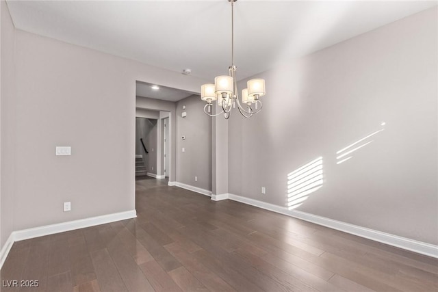 unfurnished dining area featuring dark wood-type flooring and a chandelier