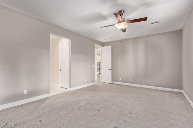 unfurnished room featuring ceiling fan and light carpet