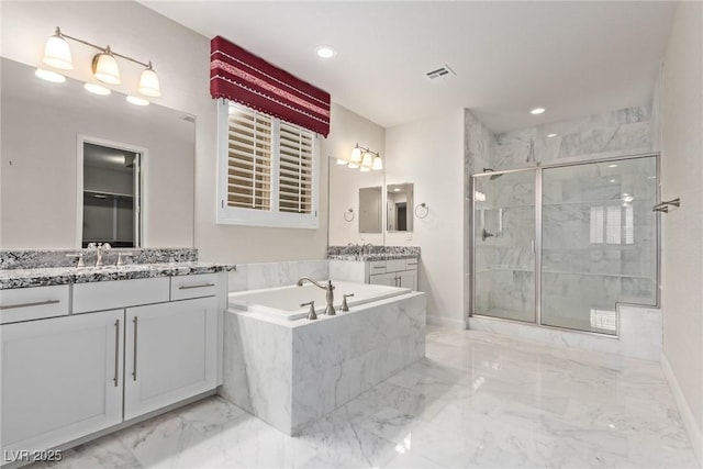 bathroom featuring vanity and separate shower and tub