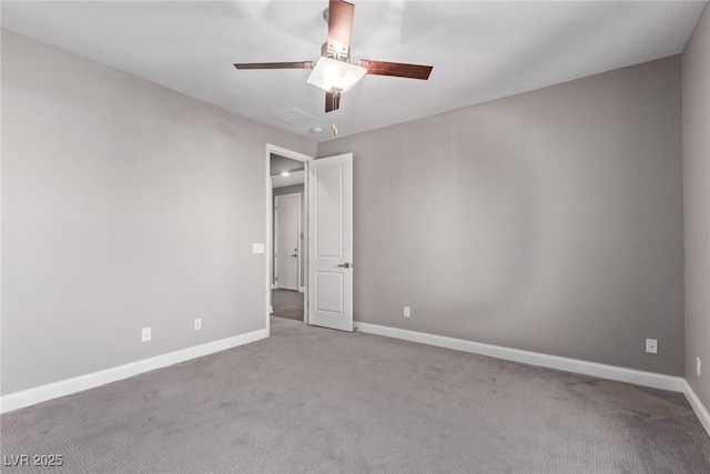 spare room with light colored carpet and ceiling fan