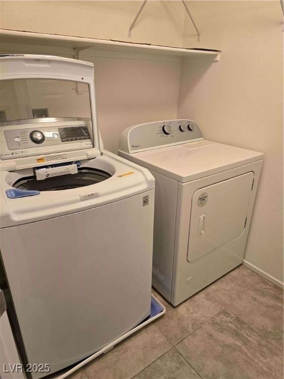 clothes washing area featuring separate washer and dryer