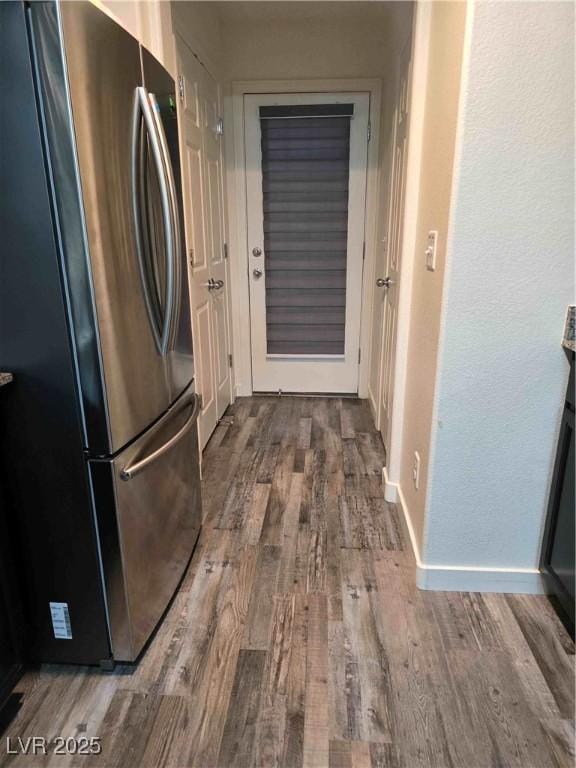 kitchen featuring stainless steel refrigerator and wood-type flooring