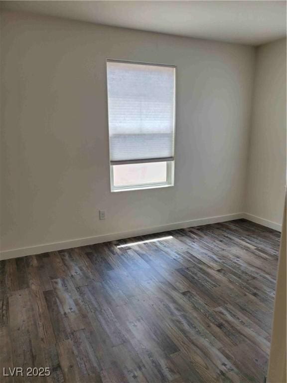 spare room featuring dark hardwood / wood-style floors