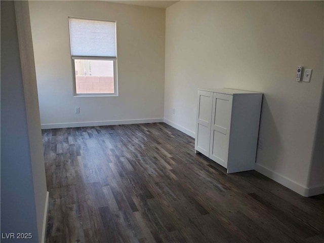 unfurnished room featuring dark wood-type flooring