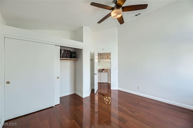 unfurnished bedroom with lofted ceiling, dark hardwood / wood-style floors, a closet, and ceiling fan