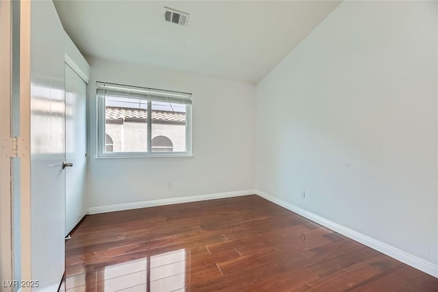 unfurnished room featuring dark wood-type flooring