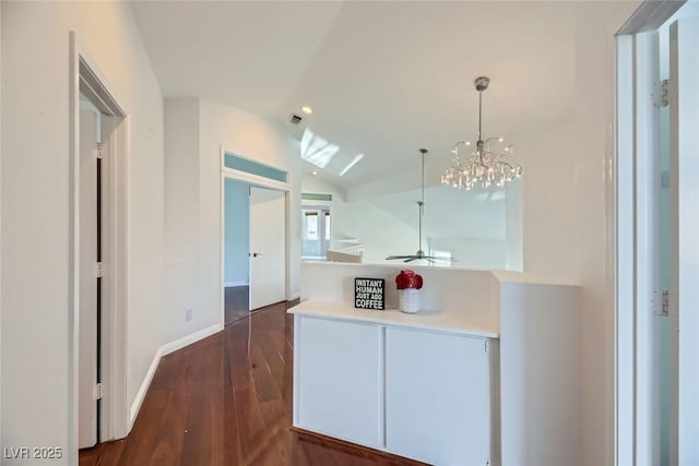 kitchen featuring lofted ceiling, dark hardwood / wood-style floors, and hanging light fixtures