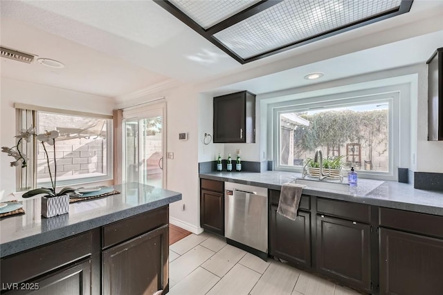 kitchen featuring sink, a wealth of natural light, dark stone counters, and dishwasher