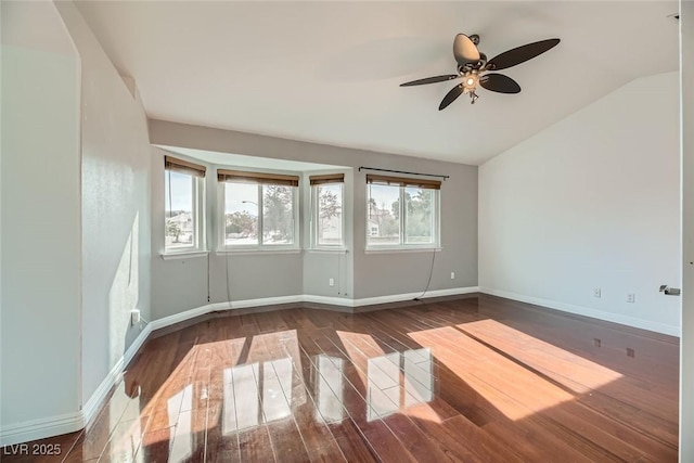 unfurnished room featuring dark wood-type flooring, ceiling fan, lofted ceiling, and plenty of natural light