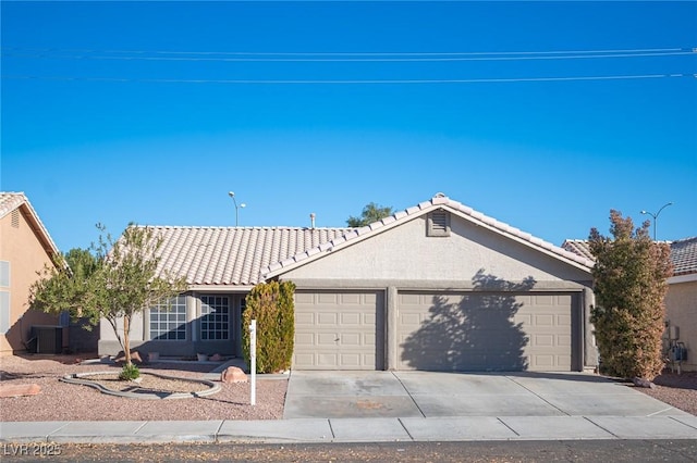 ranch-style house with a garage and central air condition unit