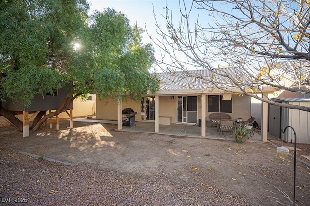 back of property featuring a patio