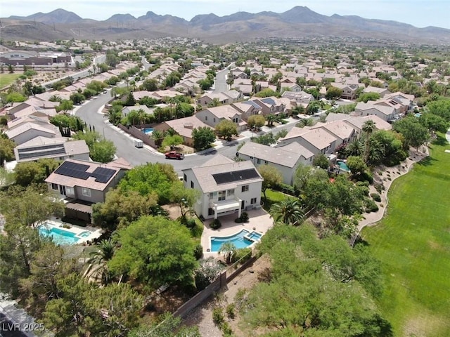 birds eye view of property with a mountain view