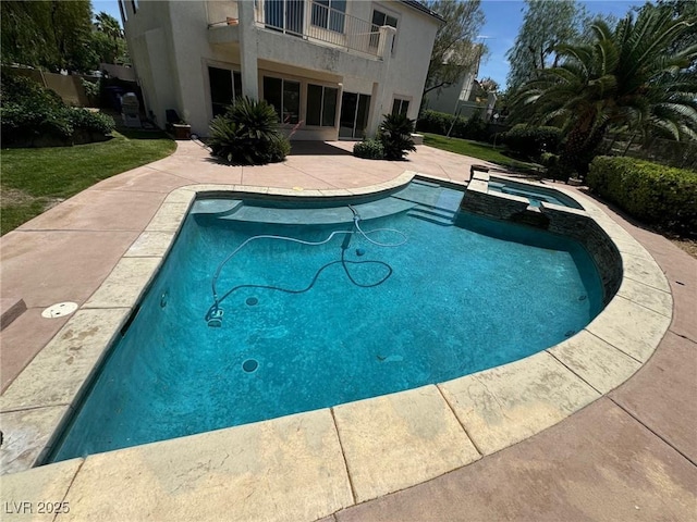 view of swimming pool featuring an in ground hot tub and a patio