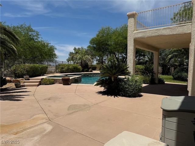 view of swimming pool with an in ground hot tub and a patio