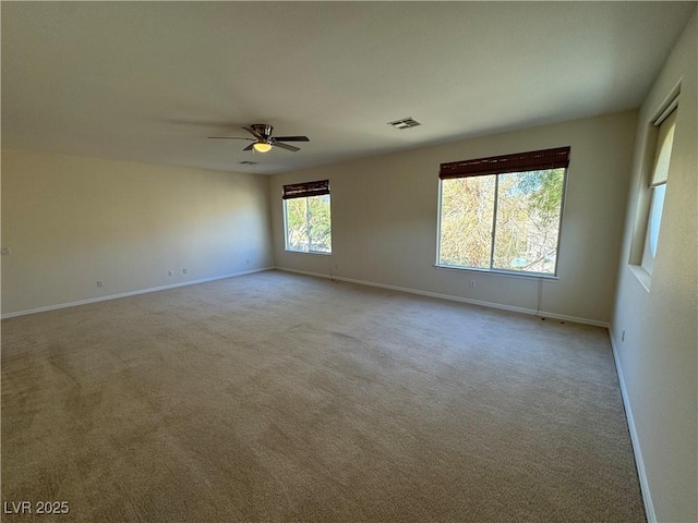 carpeted spare room with ceiling fan