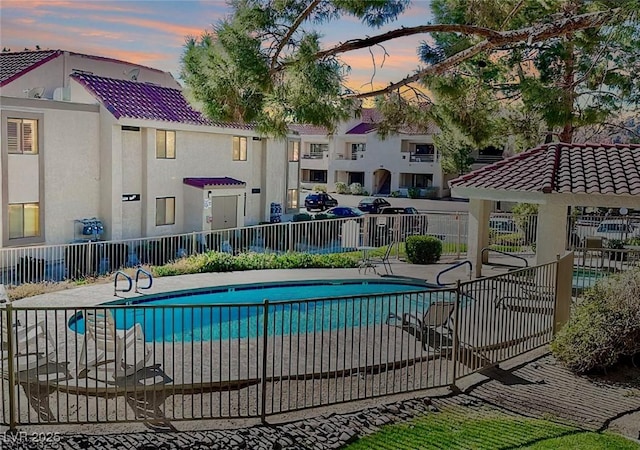 pool at dusk with a patio