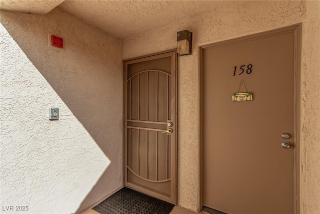 view of exterior entry with stucco siding