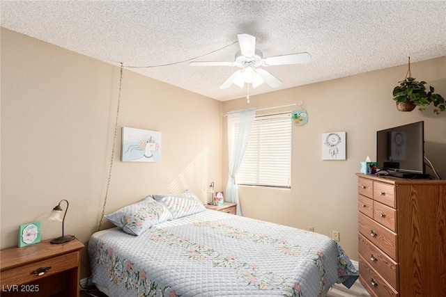 bedroom with ceiling fan and a textured ceiling