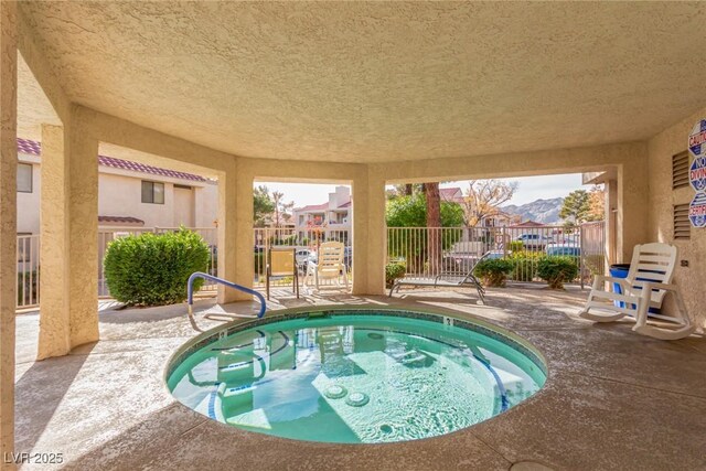 view of pool featuring a community hot tub and a patio