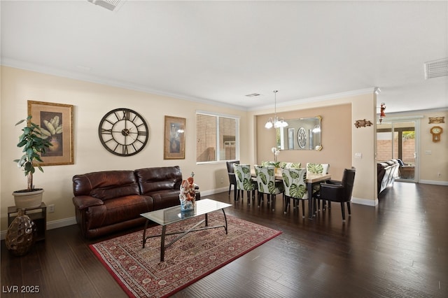 living room with ornamental molding, dark hardwood / wood-style flooring, and a chandelier