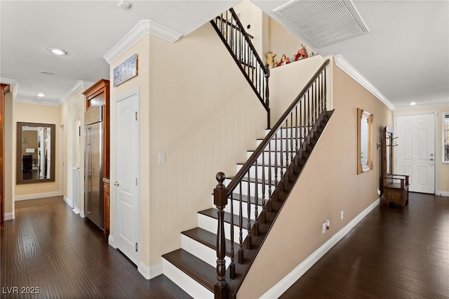 staircase with hardwood / wood-style flooring and ornamental molding