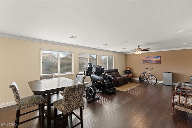 dining space featuring ornamental molding, dark hardwood / wood-style floors, and ceiling fan