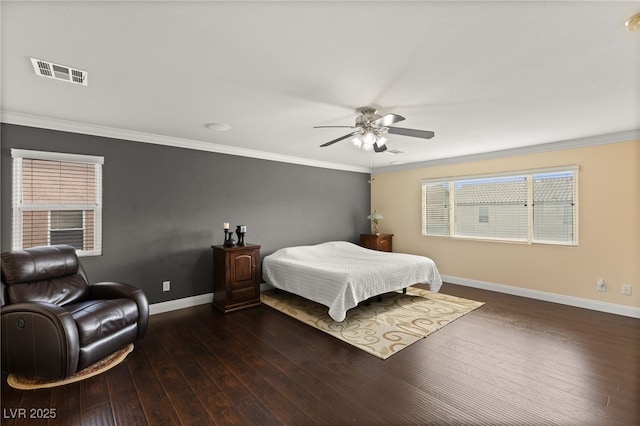 bedroom featuring dark hardwood / wood-style flooring, multiple windows, ornamental molding, and ceiling fan