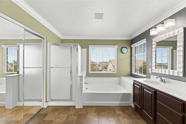 bathroom with tile patterned floors, ornamental molding, shower with separate bathtub, and vanity