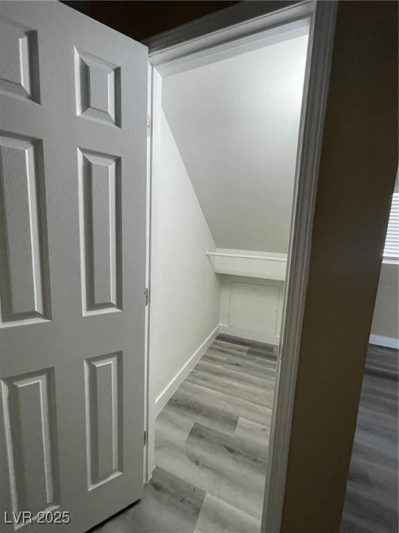 staircase with hardwood / wood-style floors