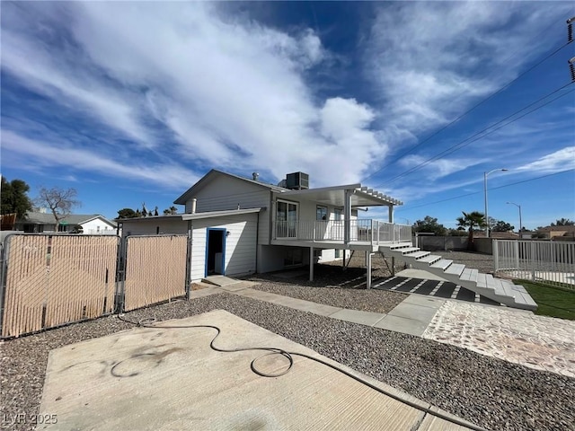 rear view of property with cooling unit