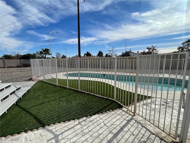 view of swimming pool featuring a patio area and a lawn