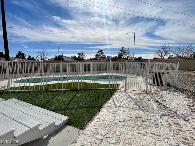 view of swimming pool with a yard and a patio