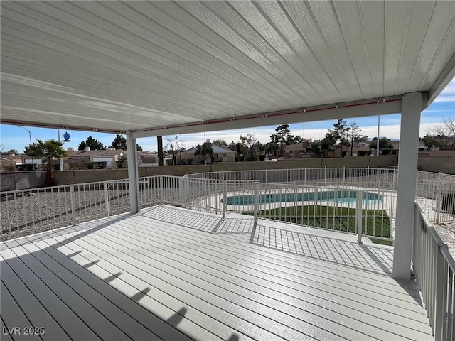 wooden terrace featuring a fenced in pool