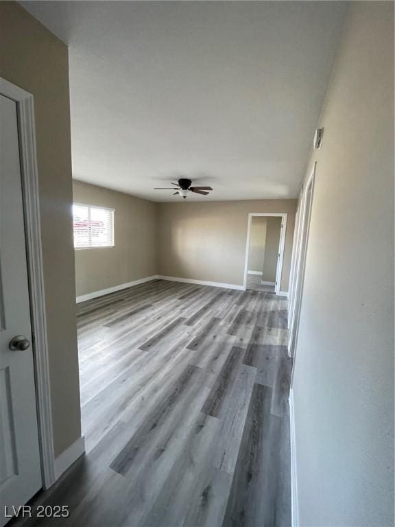 empty room featuring hardwood / wood-style flooring and ceiling fan