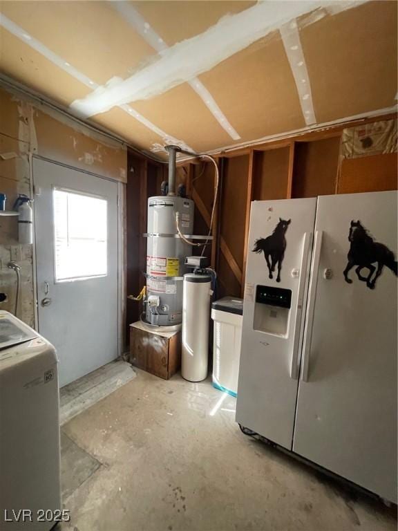 basement with gas water heater, white refrigerator with ice dispenser, and washer / dryer