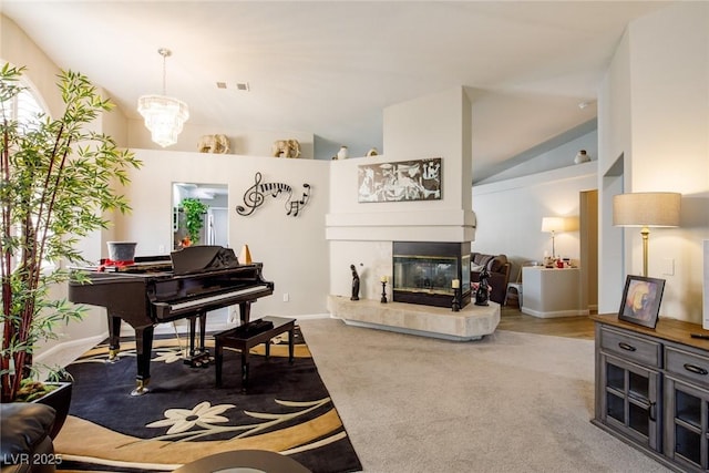 living room featuring carpet floors, a fireplace, vaulted ceiling, and a notable chandelier