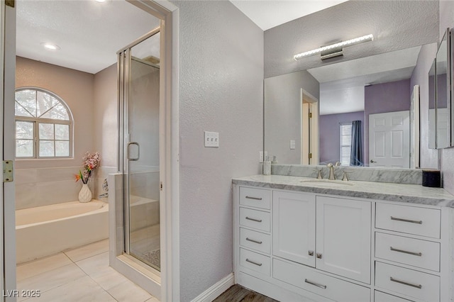 bathroom featuring plenty of natural light, separate shower and tub, and vanity