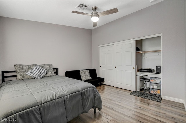 bedroom featuring ceiling fan, a closet, and light wood-type flooring