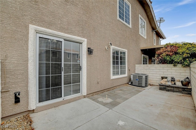 view of patio with central AC and an outdoor fire pit