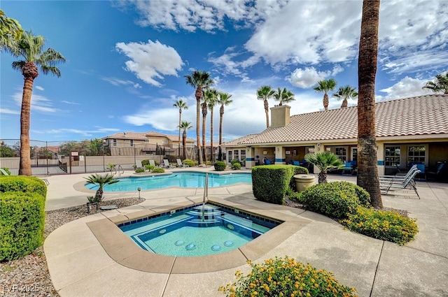 view of pool with a patio and an in ground hot tub