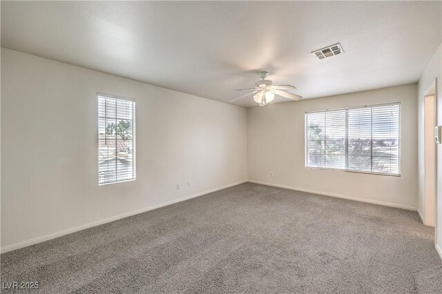 carpeted empty room featuring ceiling fan