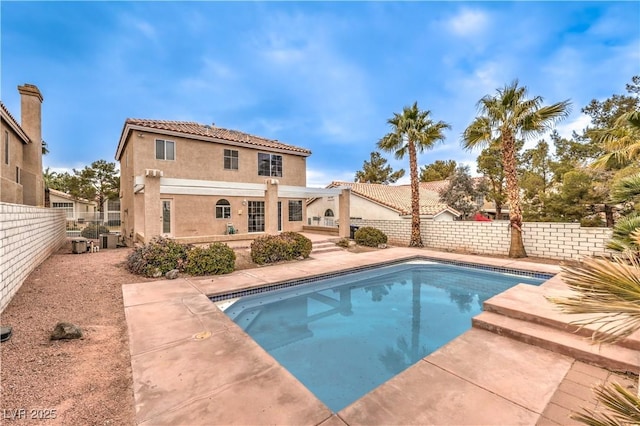 view of pool featuring cooling unit, a fenced in pool, a patio, and a fenced backyard