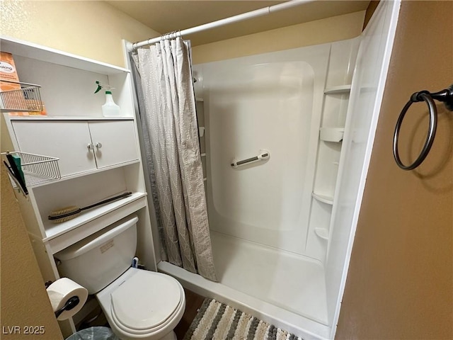 bathroom with curtained shower and toilet