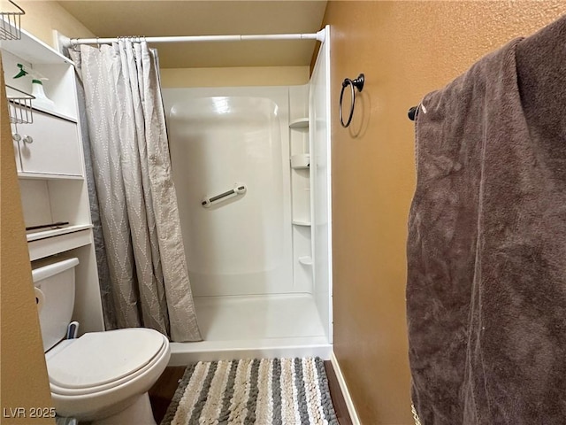 bathroom with toilet and walk in shower