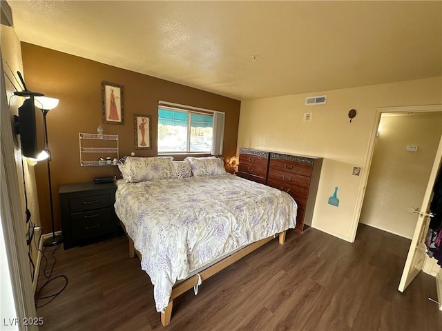 bedroom featuring dark hardwood / wood-style flooring