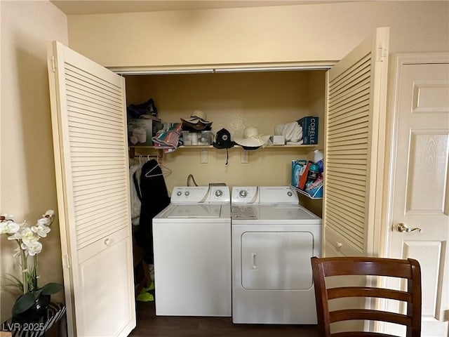 clothes washing area featuring dark hardwood / wood-style floors and washer and dryer