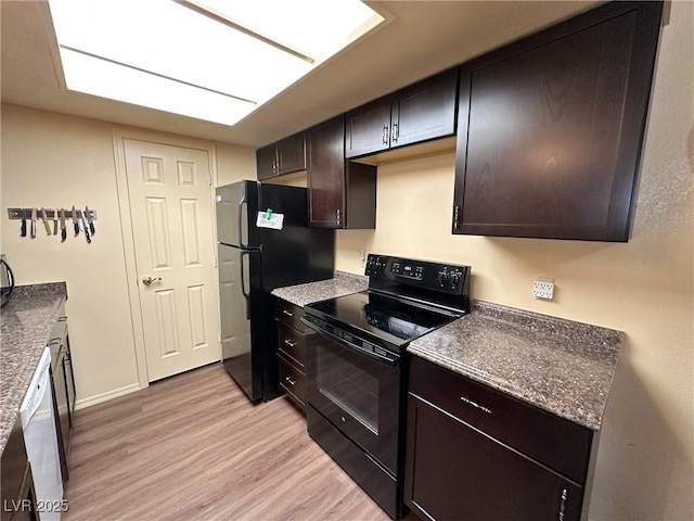 kitchen with light hardwood / wood-style floors, dark brown cabinets, and black appliances