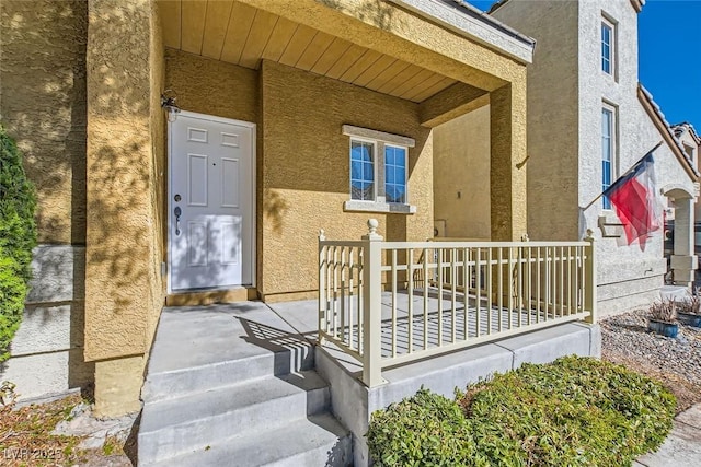 view of exterior entry with covered porch