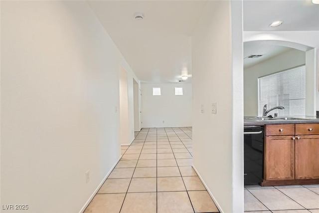 hallway with sink and light tile patterned floors