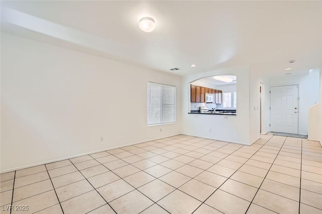 unfurnished living room with light tile patterned floors